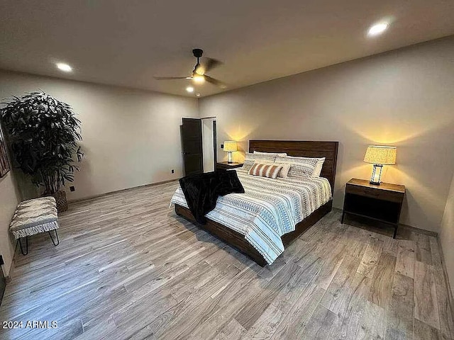 bedroom with ceiling fan and light hardwood / wood-style floors