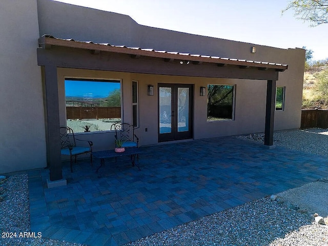 back of house with french doors and a patio area