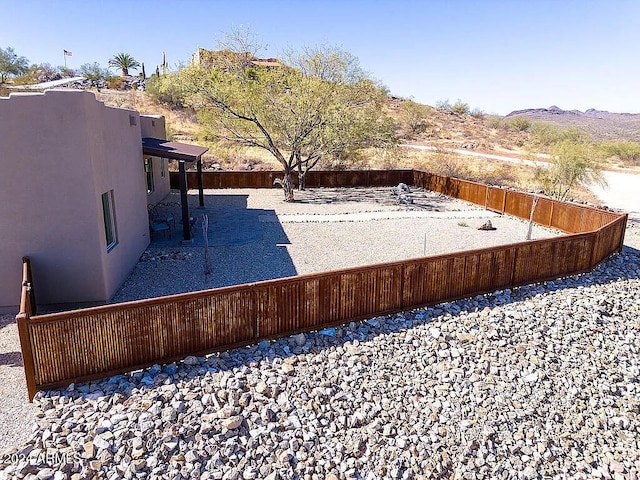 view of yard with a mountain view and a patio