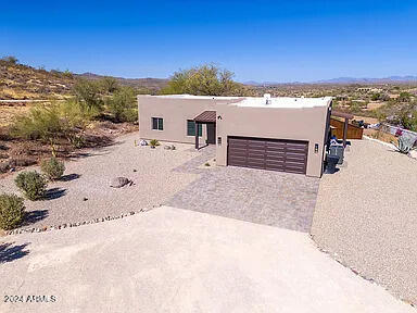 pueblo-style home featuring a garage