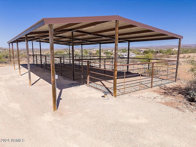 view of stable with a rural view