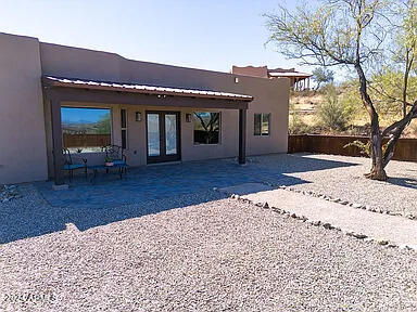 back of house with french doors and a patio