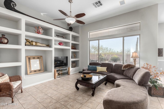 living room with ceiling fan, light tile patterned floors, and built in features