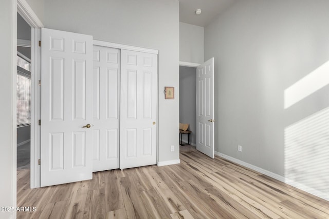 unfurnished bedroom featuring a closet and light hardwood / wood-style flooring