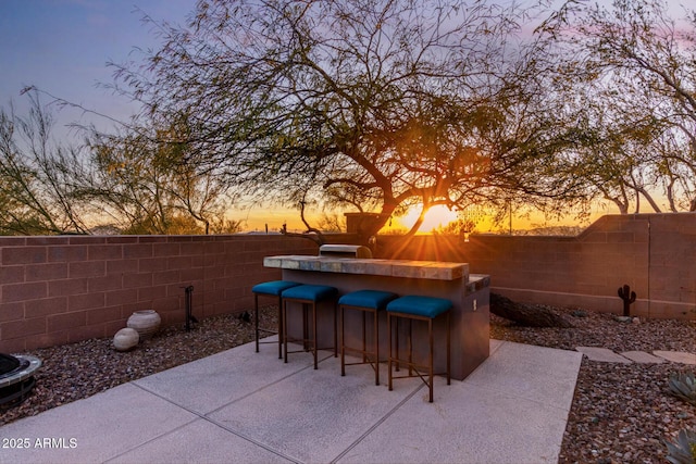 patio terrace at dusk with an outdoor bar