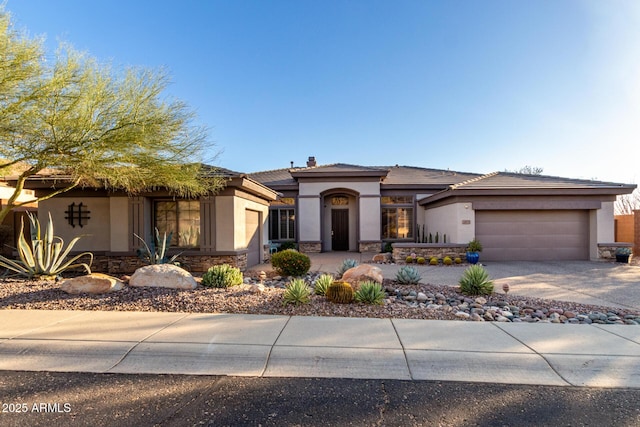 prairie-style home featuring a garage