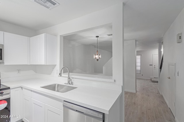 kitchen featuring appliances with stainless steel finishes, sink, decorative light fixtures, white cabinets, and light hardwood / wood-style floors