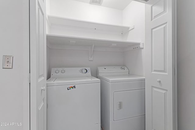 clothes washing area with washer and dryer