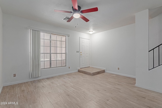 unfurnished room with ceiling fan and light hardwood / wood-style floors