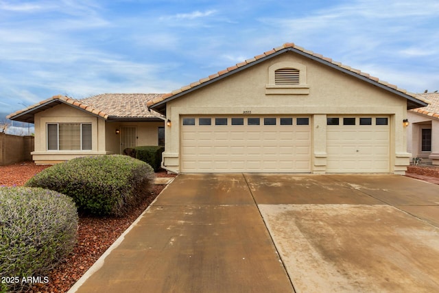 ranch-style house featuring stucco siding, concrete driveway, an attached garage, and a tile roof