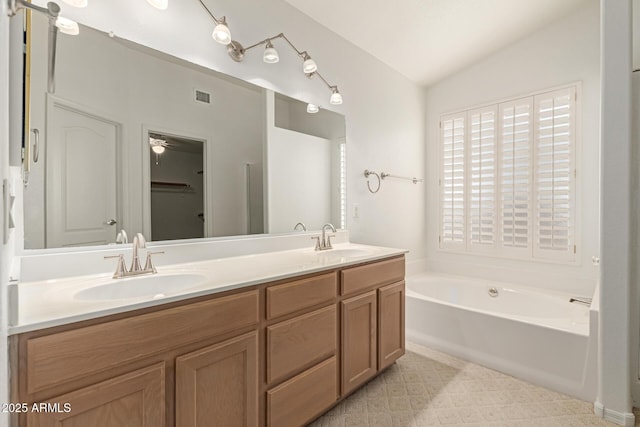 full bathroom with a sink, a garden tub, double vanity, and vaulted ceiling