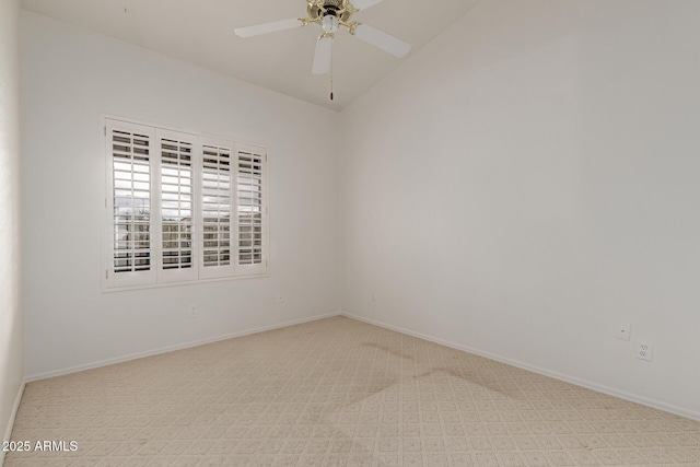 unfurnished room with lofted ceiling, baseboards, carpet, and a ceiling fan