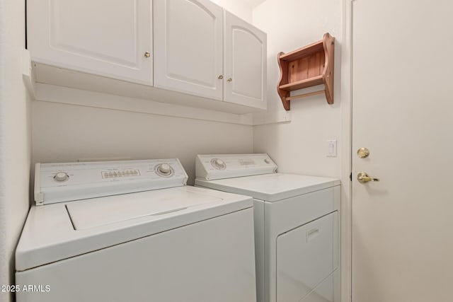 clothes washing area with cabinet space and washing machine and clothes dryer