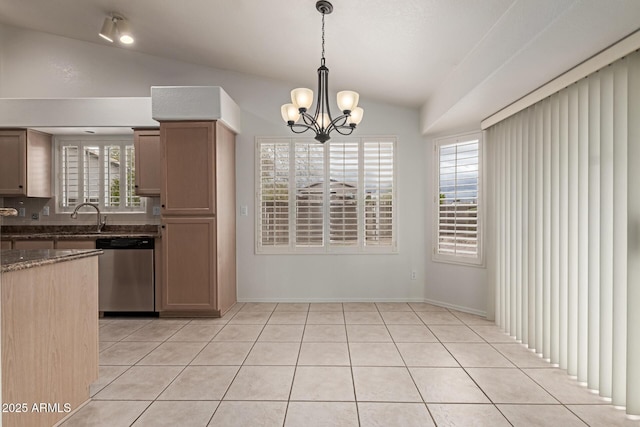 kitchen with lofted ceiling, stainless steel dishwasher, light tile patterned flooring, and plenty of natural light