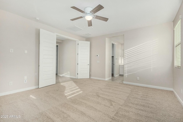 unfurnished bedroom with ceiling fan and light carpet