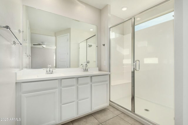 bathroom with ceiling fan, vanity, an enclosed shower, and tile patterned flooring