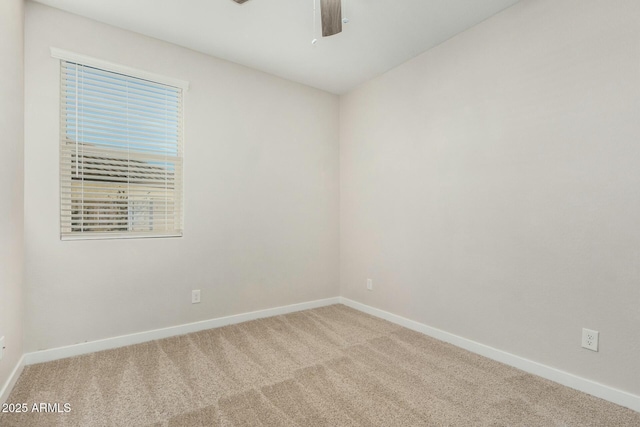 spare room with carpet and ceiling fan