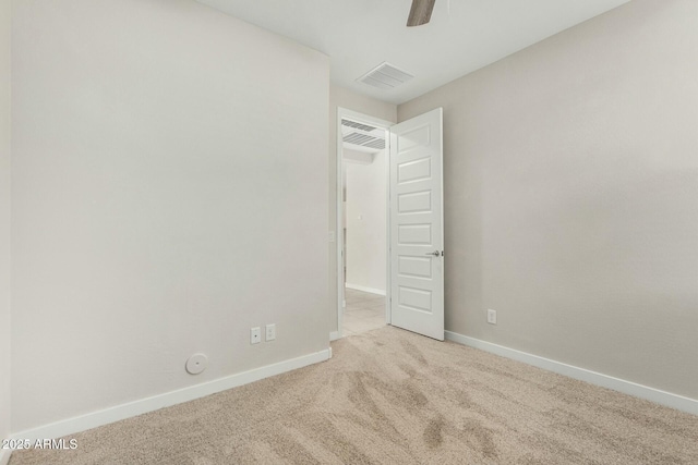 unfurnished bedroom with ceiling fan and light colored carpet