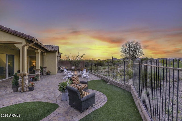 yard at dusk featuring a fire pit and a patio area