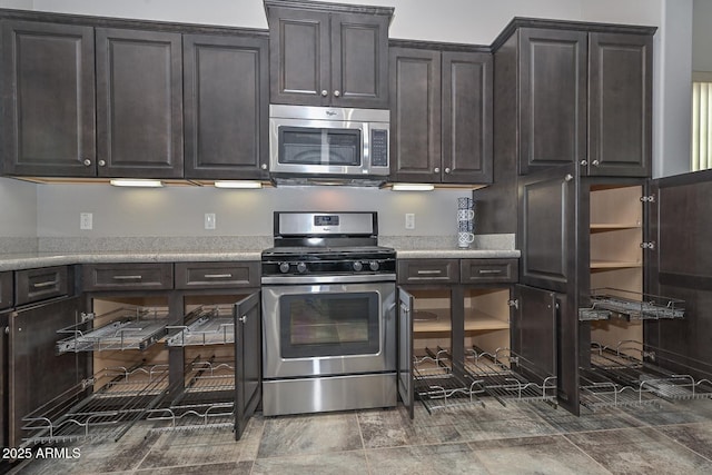 kitchen featuring dark brown cabinets and appliances with stainless steel finishes