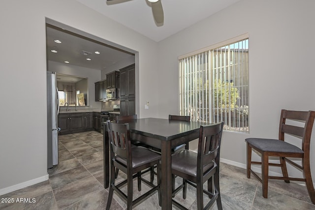 dining space with ceiling fan and sink