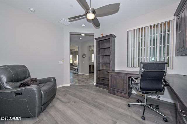 office area with light hardwood / wood-style floors and ceiling fan