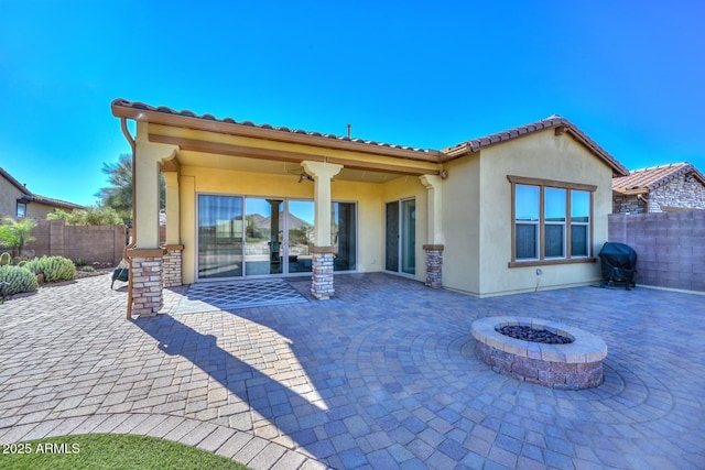 rear view of house featuring a patio, an outdoor fire pit, and ceiling fan