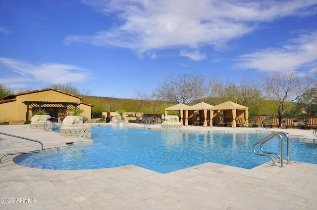 view of swimming pool featuring a patio and a gazebo