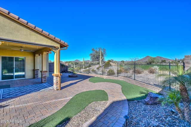 view of yard with a patio area and ceiling fan