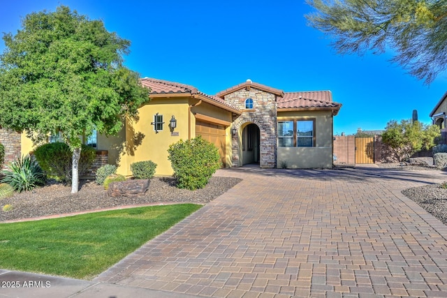 mediterranean / spanish-style home with a garage