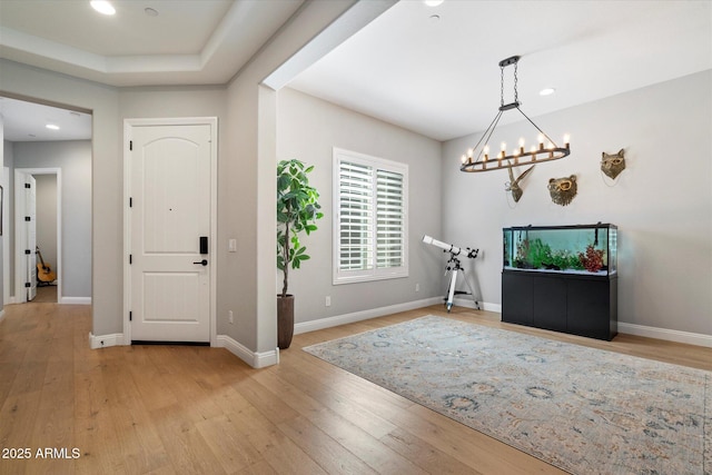 entrance foyer with a chandelier, recessed lighting, and light wood finished floors