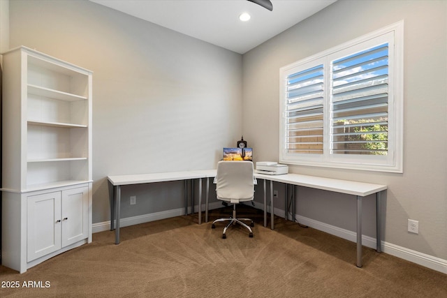 carpeted home office with baseboards