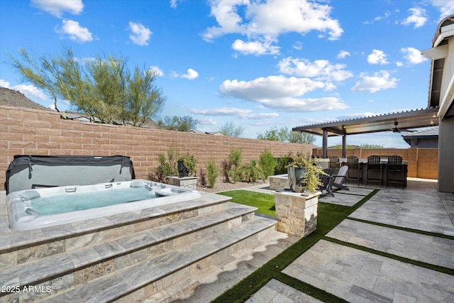 view of yard featuring a pergola, a patio area, a covered hot tub, and a fenced backyard