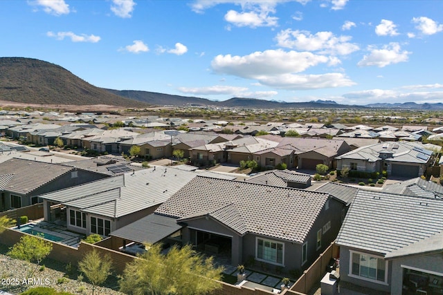 drone / aerial view featuring a residential view and a mountain view