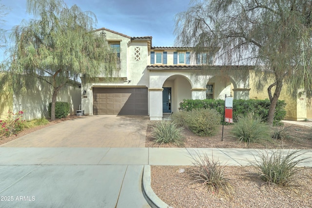 mediterranean / spanish-style house with a garage