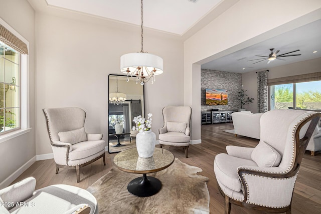 6328 W Fetlock Trl, Phoenix, AZ 85083 - sitting room featuring ceiling fan with notable chandelier, baseboards, and wood finished floors