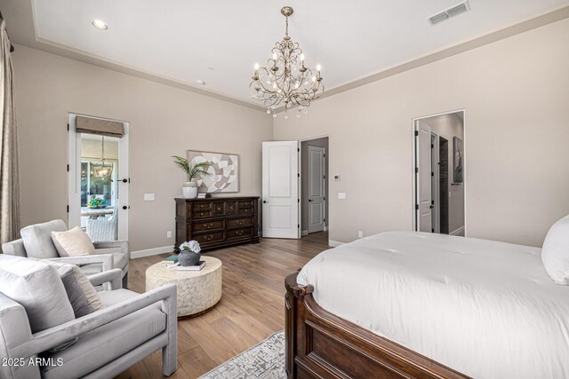6328 W Fetlock Trl, Phoenix, AZ 85083 - bedroom with wood finished floors, visible vents, baseboards, recessed lighting, and a notable chandelier