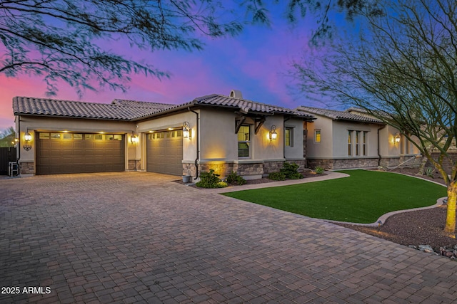 6328 W Fetlock Trl, Phoenix, AZ 85083 - mediterranean / spanish house with an attached garage, stucco siding, stone siding, a tiled roof, and decorative driveway