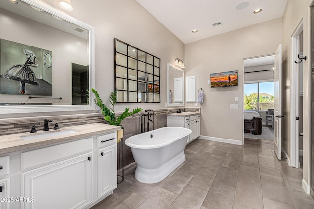 6328 W Fetlock Trl, Phoenix, AZ 85083 - full bathroom featuring visible vents, two vanities, recessed lighting, a freestanding tub, and a sink