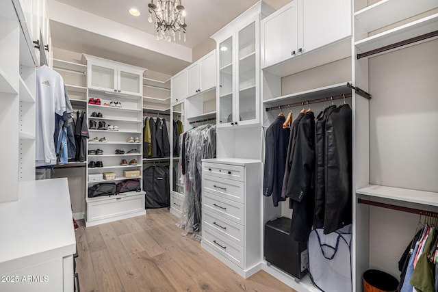 6328 W Fetlock Trl, Phoenix, AZ 85083 - spacious closet featuring a notable chandelier and light wood finished floors