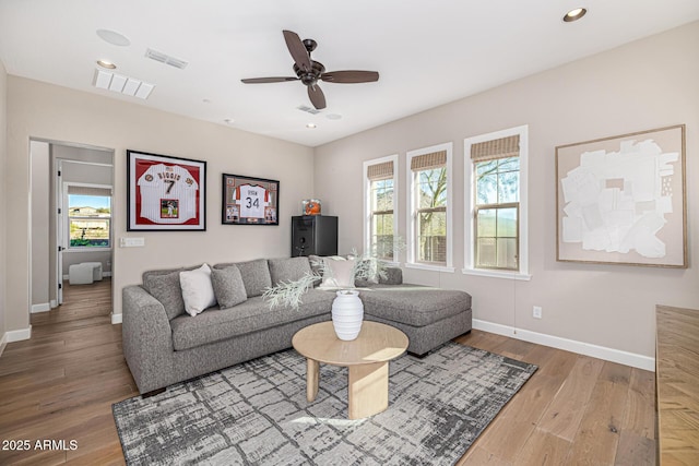 6328 W Fetlock Trl, Phoenix, AZ 85083 - living room with visible vents, baseboards, and wood finished floors