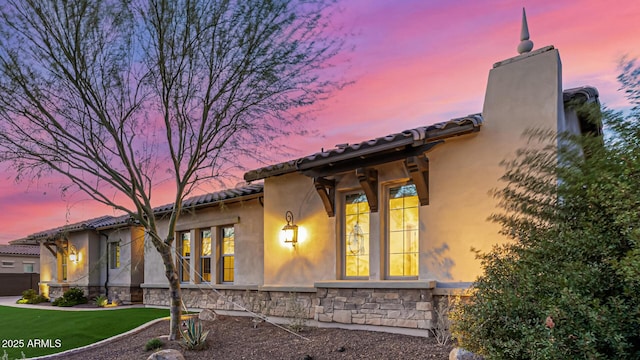 6328 W Fetlock Trl, Phoenix, AZ 85083 - exterior space featuring a chimney, stone siding, stucco siding, and a tile roof
