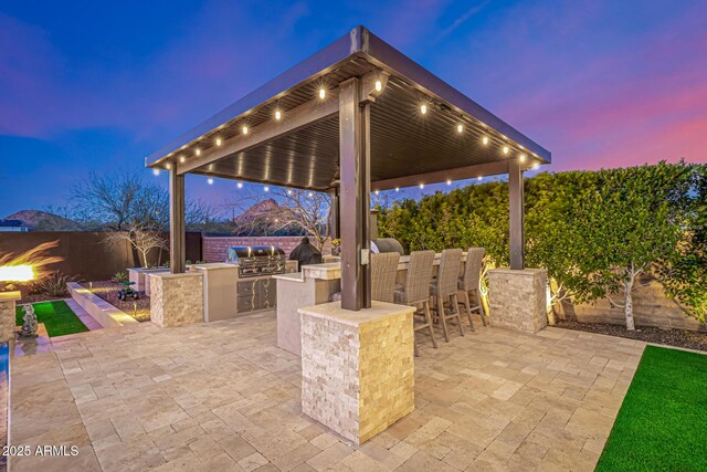 6328 W Fetlock Trl, Phoenix, AZ 85083 - view of patio / terrace featuring a fenced backyard, a grill, an outdoor kitchen, and outdoor wet bar