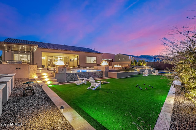 6328 W Fetlock Trl, Phoenix, AZ 85083 - view of yard featuring ceiling fan, a fenced in pool, and an outdoor kitchen