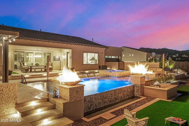 6328 W Fetlock Trl, Phoenix, AZ 85083 - pool at dusk featuring an outdoor pool, a patio, an in ground hot tub, and an outdoor fire pit