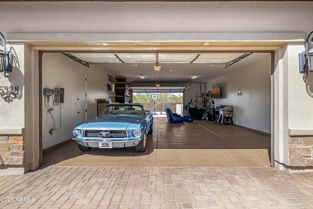 6328 W Fetlock Trl, Phoenix, AZ 85083 - garage with baseboards and a garage door opener