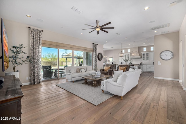 6328 W Fetlock Trl, Phoenix, AZ 85083 - living room featuring light wood-style flooring, a ceiling fan, and visible vents