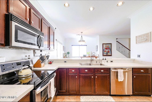 kitchen featuring sink, hanging light fixtures, crown molding, light tile patterned floors, and appliances with stainless steel finishes