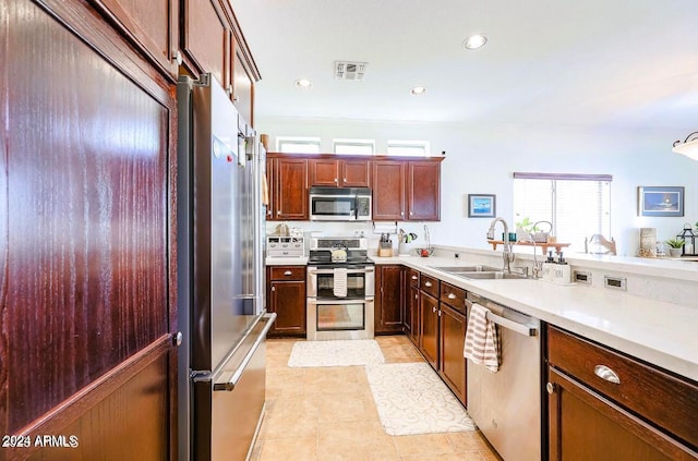 kitchen featuring sink, light tile patterned floors, and stainless steel appliances