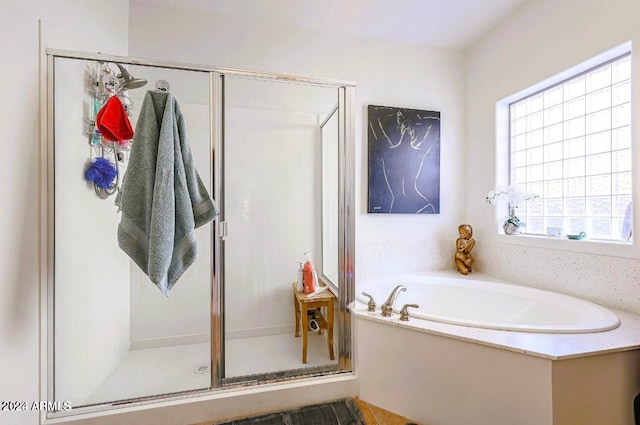 bathroom with separate shower and tub